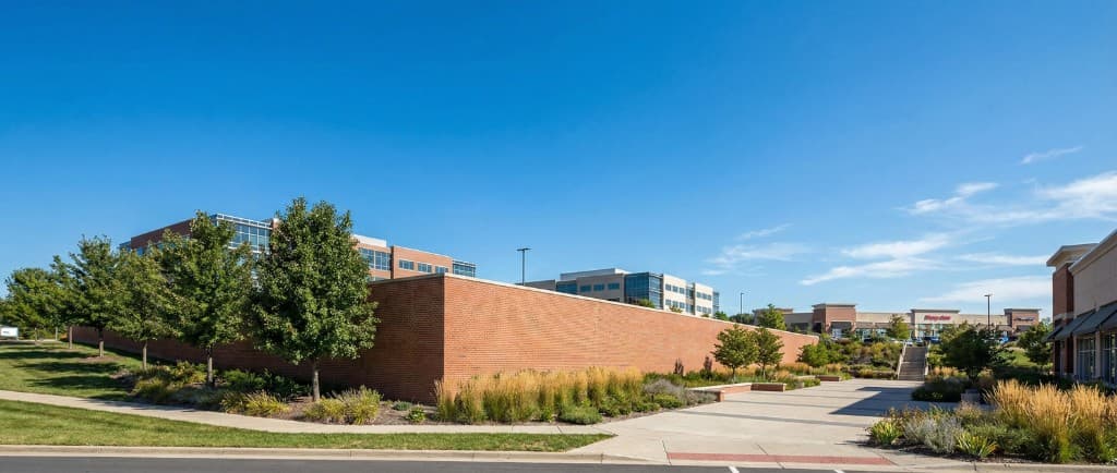 Sample commercial brick wall and landscaping — layout demo imagery