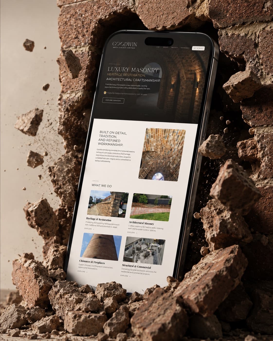 Goodwin Bricklaying website on a smartphone bursting through a heritage brick wall
